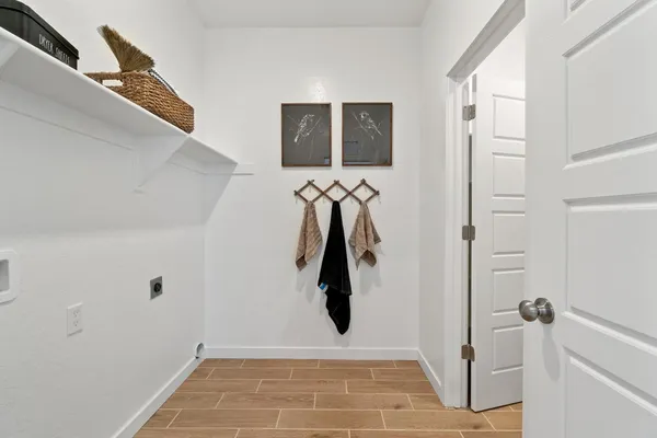 a living room with a balcony a bed furniture a chandelier and a window
