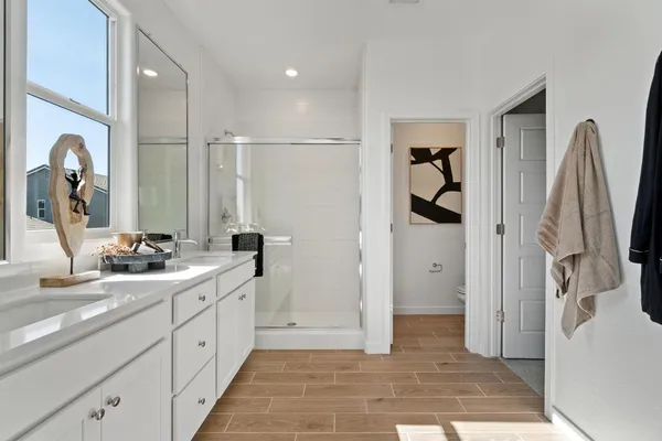 a bathroom with a toilet a sink and shower