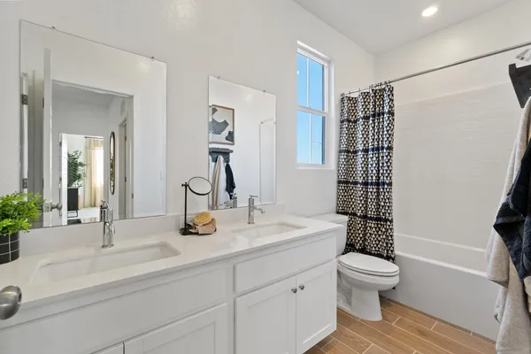 a bedroom with bed and a potted plant