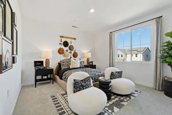 a bedroom with a bed wooden floor and window