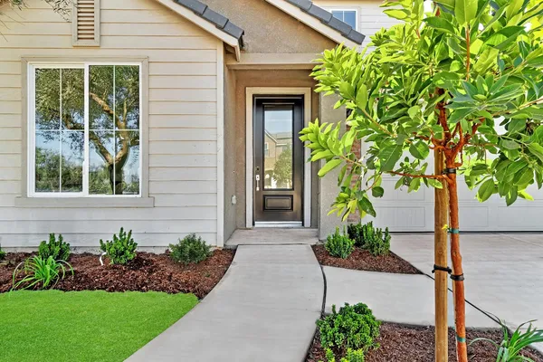 a front view of a house with a garden