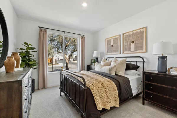 a bedroom with bed and a potted plant