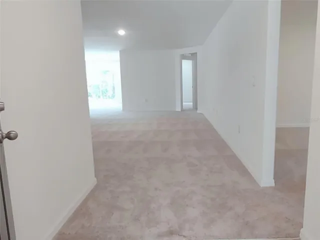 a view of an empty room with kitchen