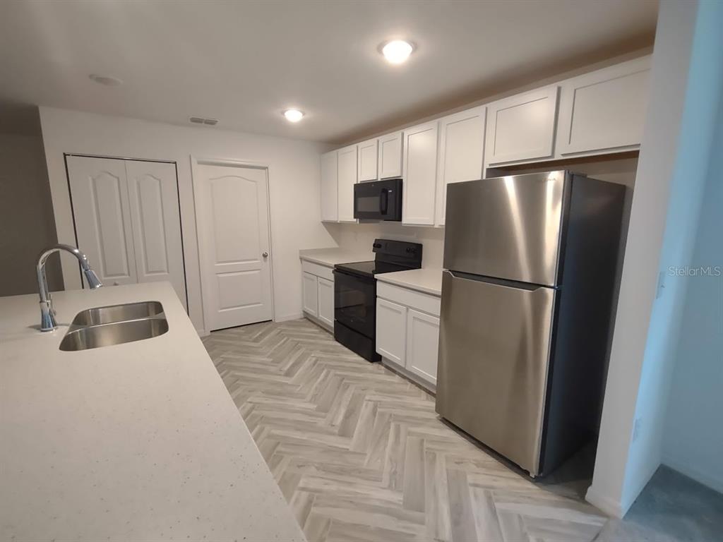 108 West Goldcoast Place Dunnellon, FL 34434 - Photo 4 of 26 a kitchen with a refrigerator sink and cabinets