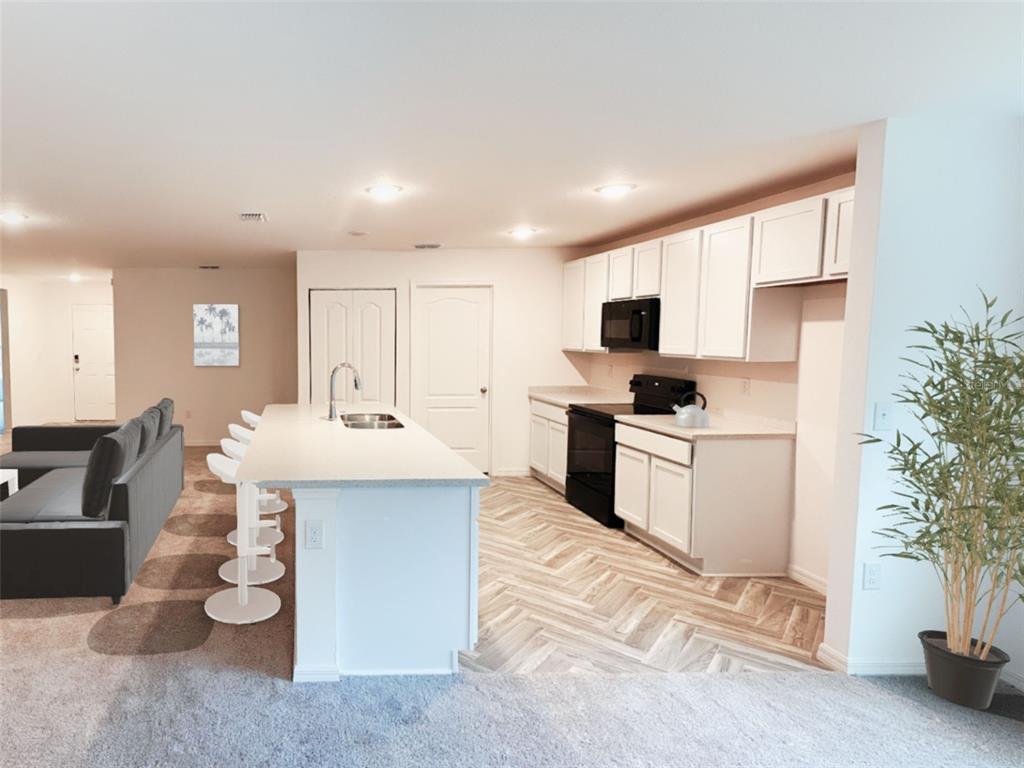 108 West Goldcoast Place Dunnellon, FL 34434 - Photo 6 of 26 a kitchen with a sink stainless steel appliances and white cabinets