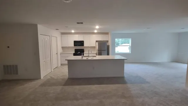 a view of a kitchen with a sink and a fireplace