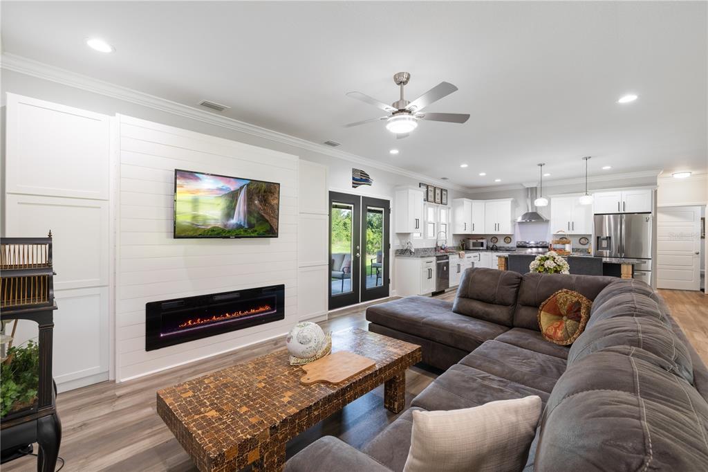 5149 Southwest 119th Road Lake Butler, FL 32054 - Photo 5 of 40 a living room with furniture kitchen view and a fireplace