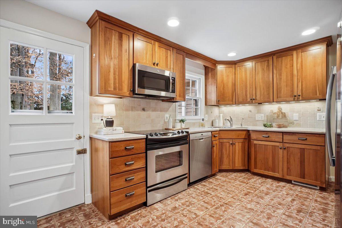 10113 Cardinal Road Fairfax, VA 22030 - Photo 12 of 59 a kitchen with stainless steel appliances granite countertop a stove a sink and a microwave