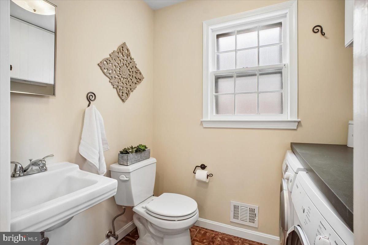 10113 Cardinal Road Fairfax, VA 22030 - Photo 20 of 59 a white toilet sitting next to a bathroom sink