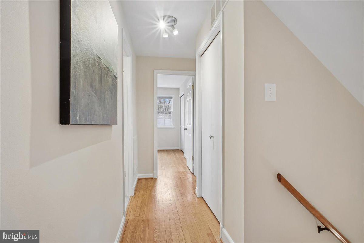 10113 Cardinal Road Fairfax, VA 22030 - Photo 22 of 59 a view of a hallway with wooden floor and staircase