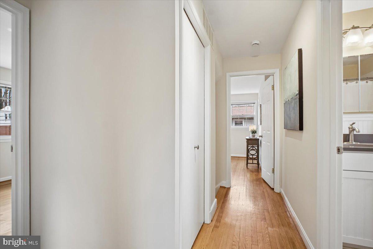 10113 Cardinal Road Fairfax, VA 22030 - Photo 23 of 59 a view of a hallway with wooden floor and a living room
