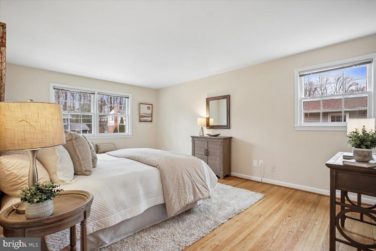 10113 Cardinal Road Fairfax, VA 22030 - Photo 24 of 59 a bedroom with a bed and wooden floor