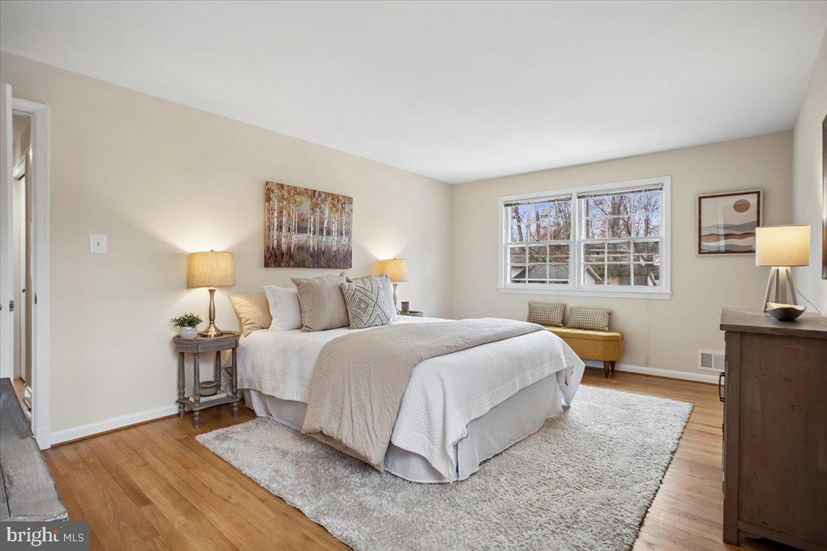 10113 Cardinal Road Fairfax, VA 22030 - Photo 25 of 59 a bedroom with a bed and wooden floor
