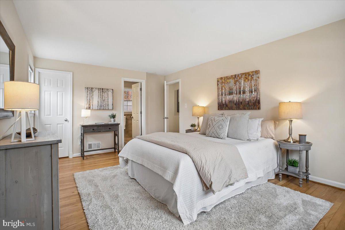10113 Cardinal Road Fairfax, VA 22030 - Photo 26 of 59 a bedroom with a bed and a lamp