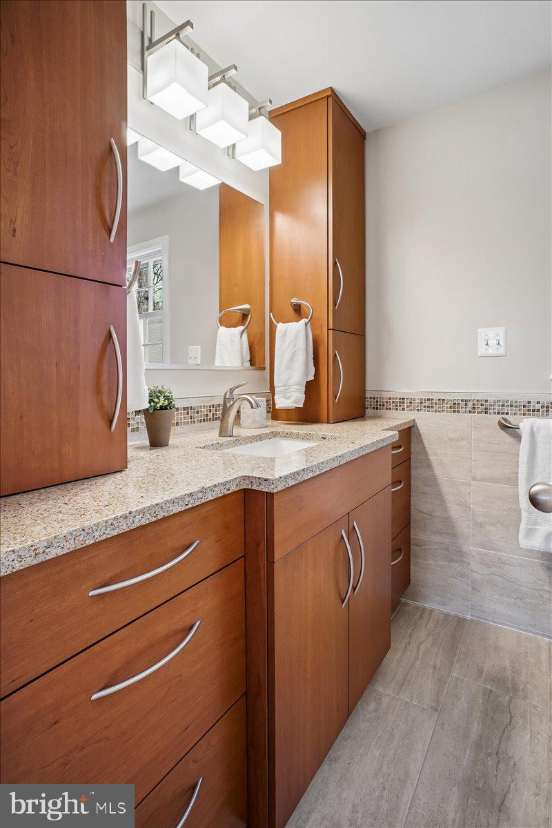 10113 Cardinal Road Fairfax, VA 22030 - Photo 29 of 59 a bathroom with a sink and a mirror