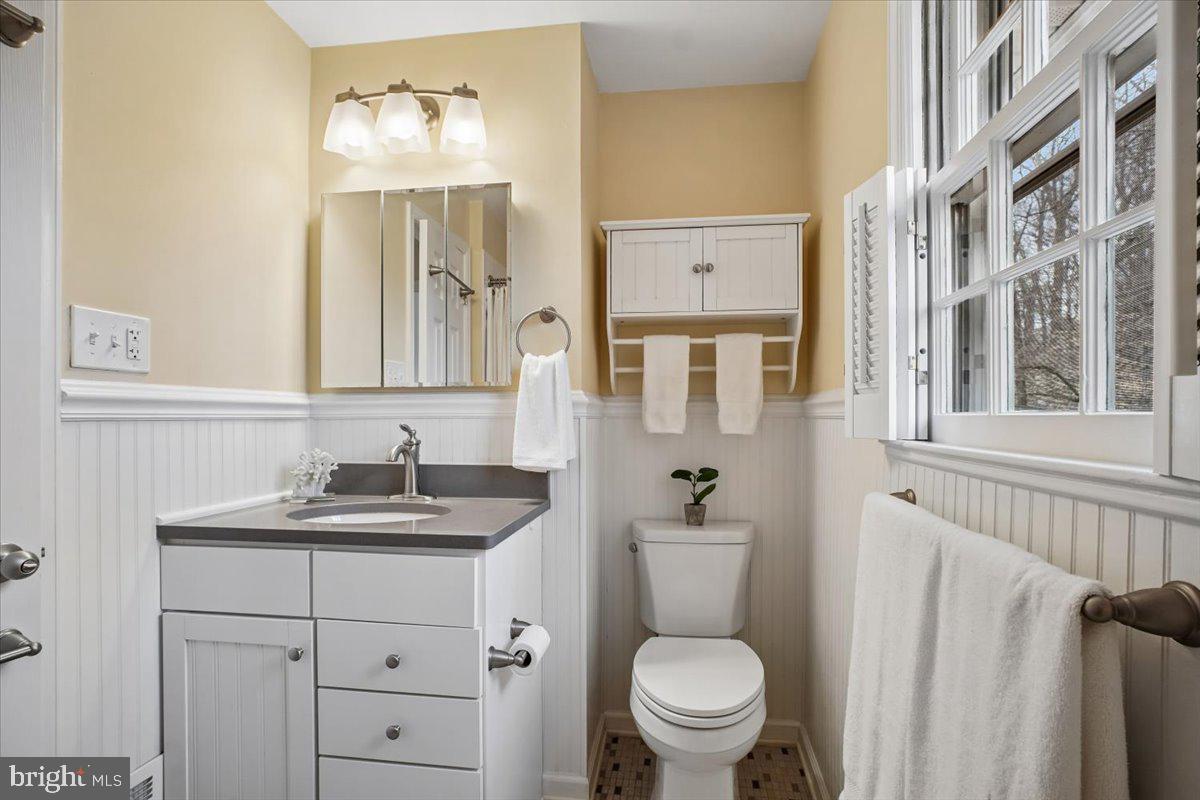 10113 Cardinal Road Fairfax, VA 22030 - Photo 35 of 59 a bathroom with a granite countertop toilet sink and mirror
