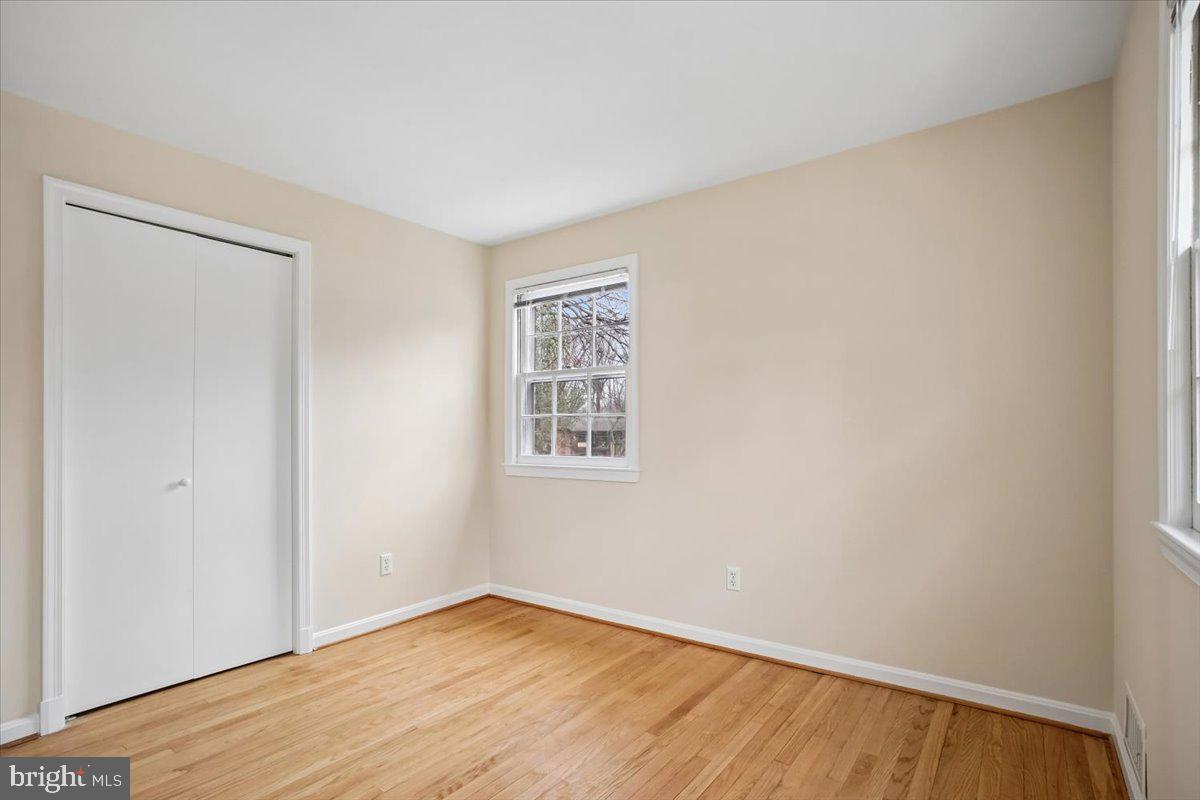10113 Cardinal Road Fairfax, VA 22030 - Photo 38 of 59 an empty room with wooden floor and windows