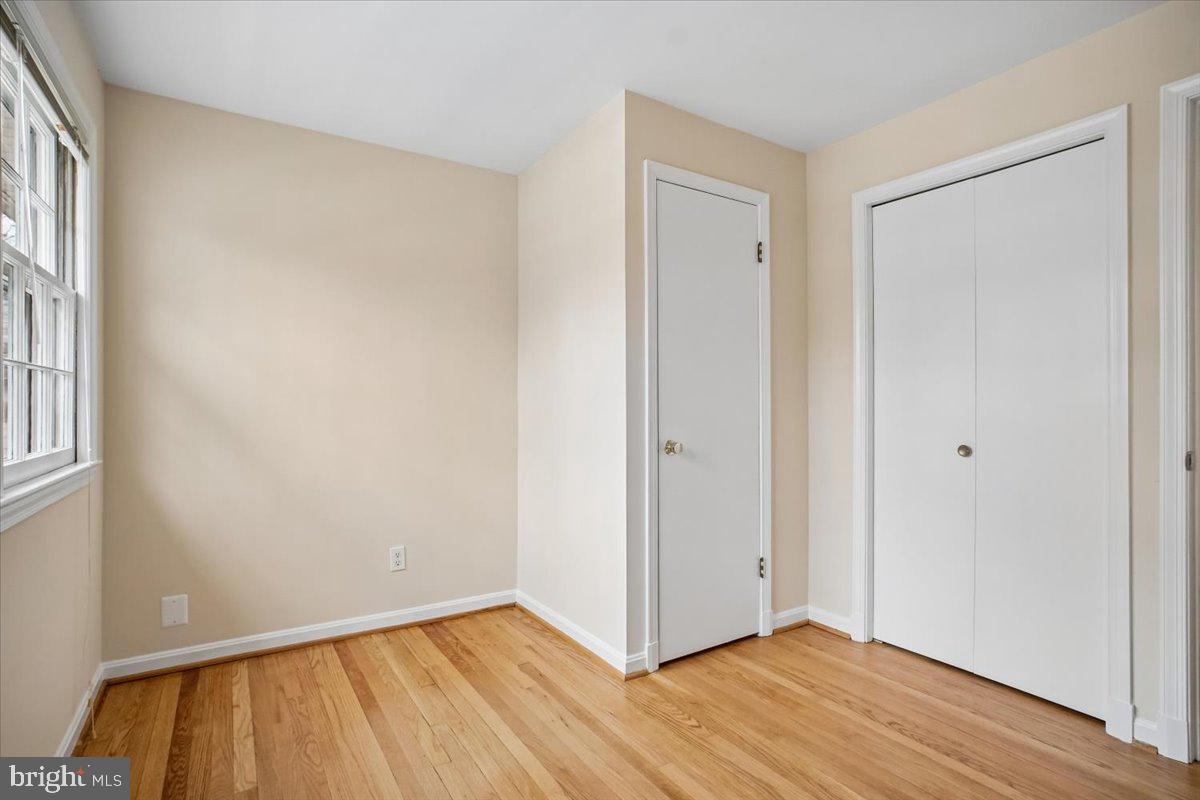 10113 Cardinal Road Fairfax, VA 22030 - Photo 40 of 59 a view of an empty room with wooden floor and a window
