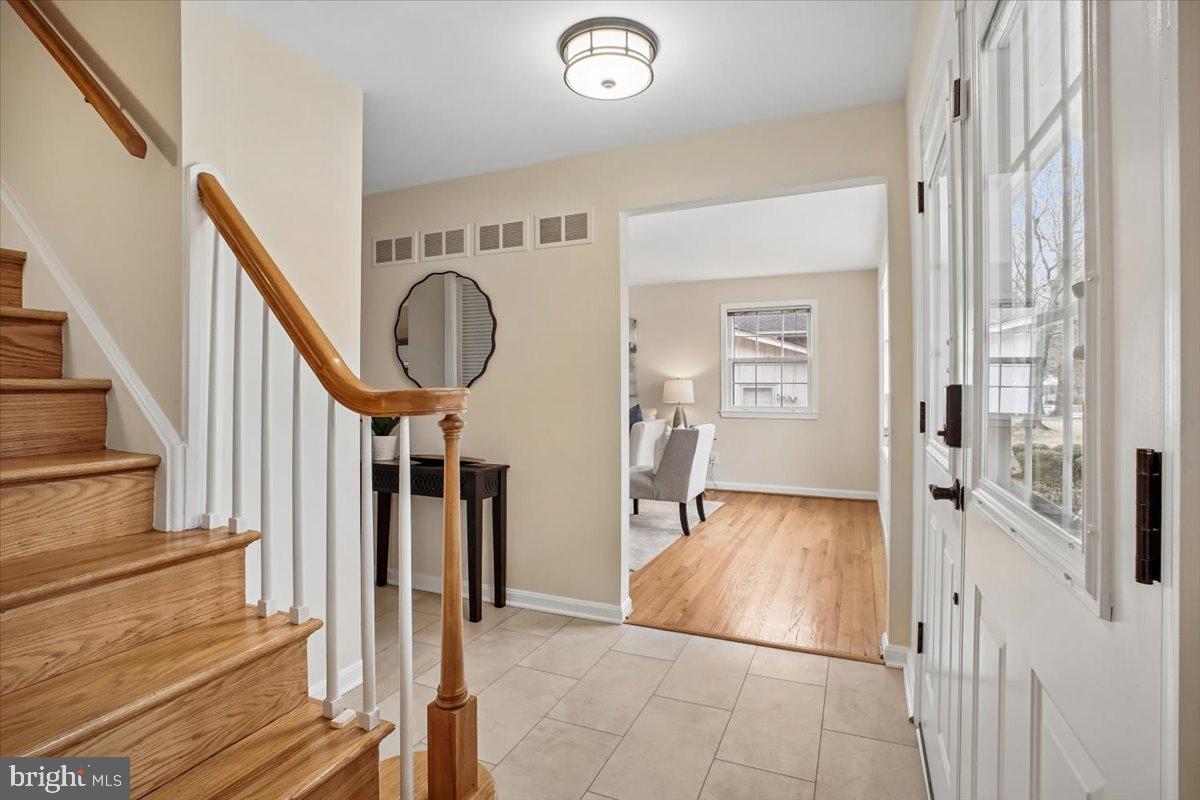 10113 Cardinal Road Fairfax, VA 22030 - Photo 4 of 59 a view of a hallway with wooden floor and staircase