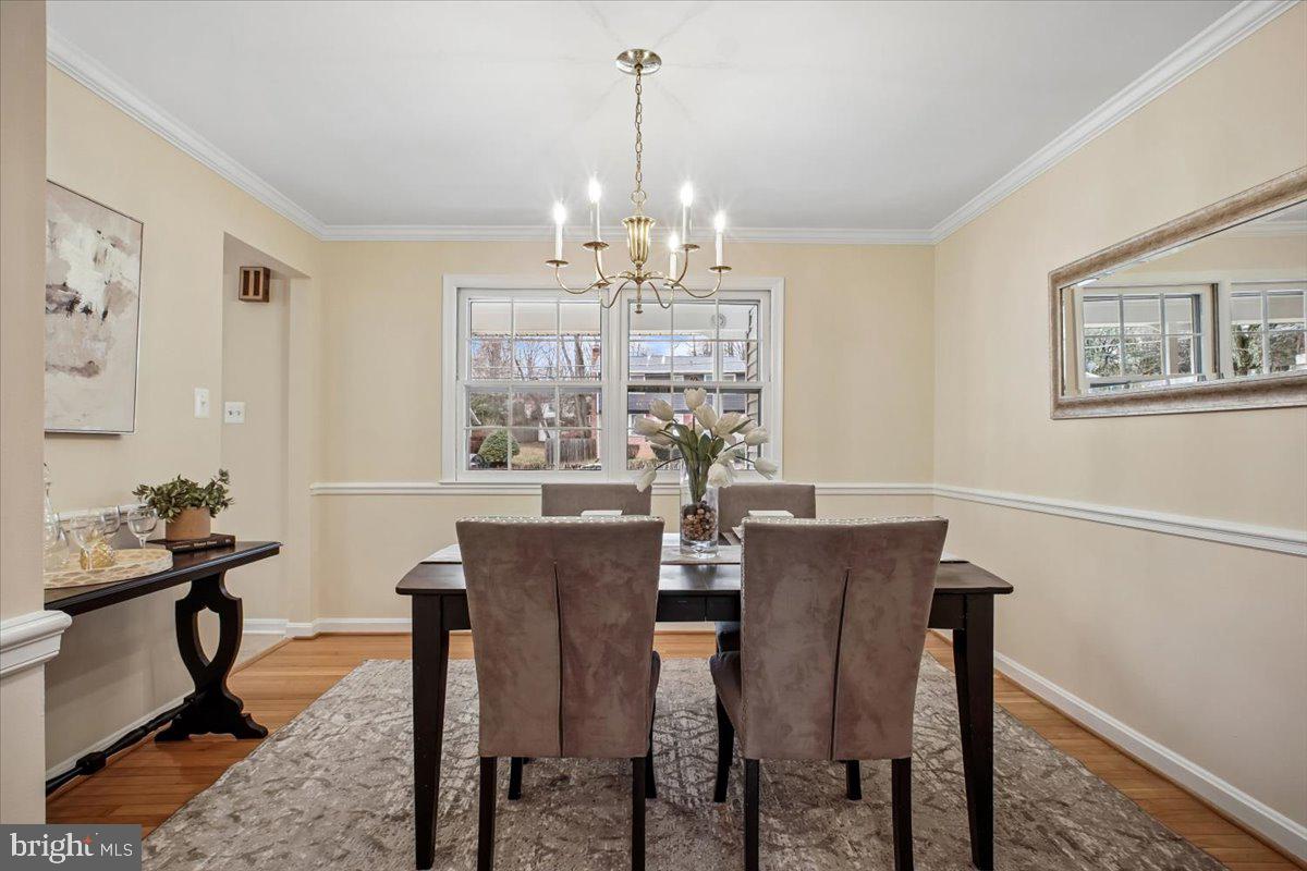 10113 Cardinal Road Fairfax, VA 22030 - Photo 9 of 59 a view of a dining room with furniture a chandelier and wooden floor