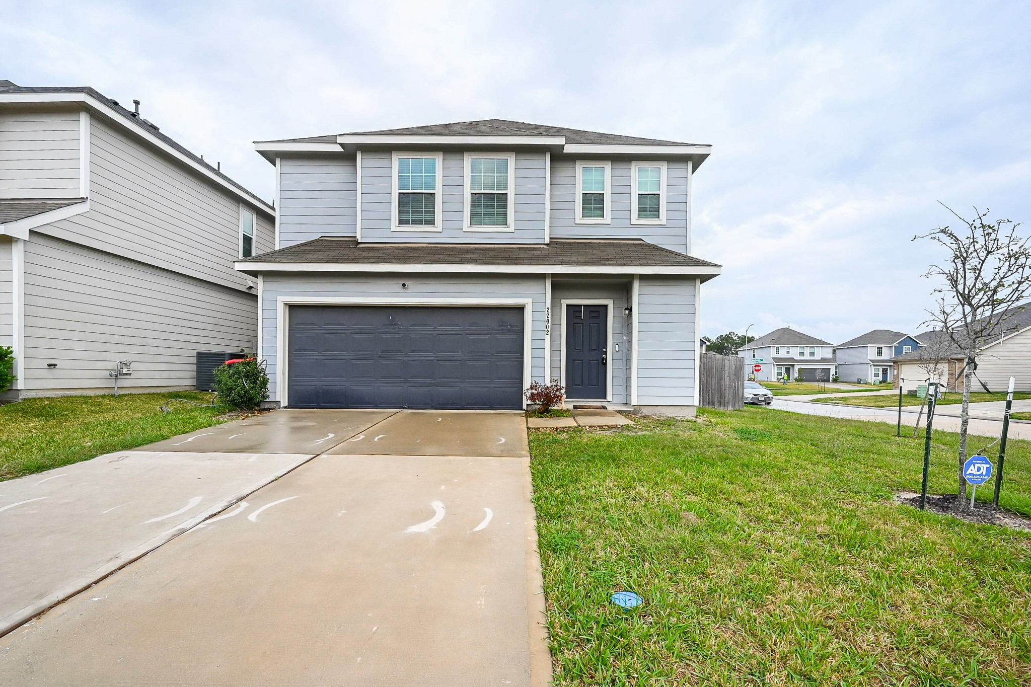 22002 Imperious Parkway Houston, TX 77073 - Photo 1 of 20 a front view of a house with a yard and garage