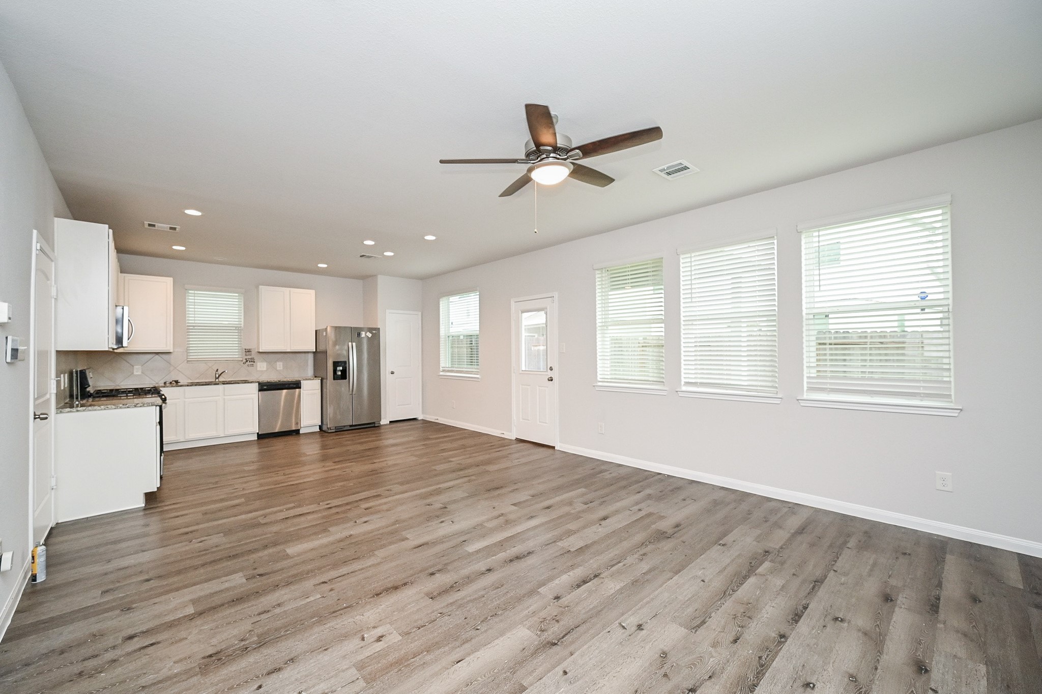 22002 Imperious Parkway Houston, TX 77073 - Photo 5 of 20 a view of an empty room with wooden floor and a window