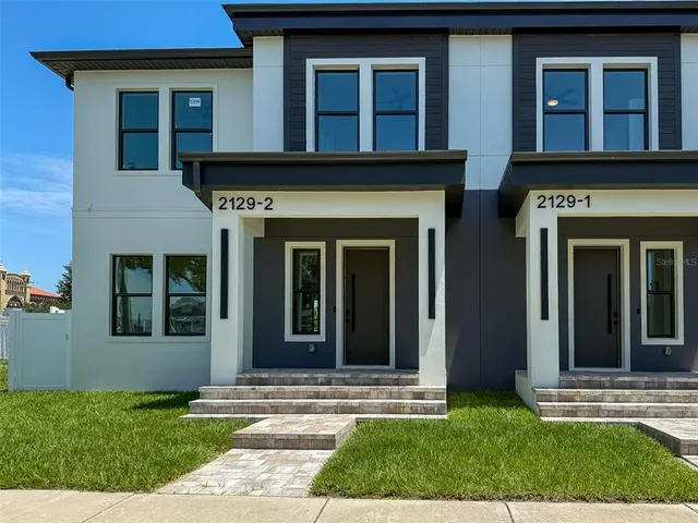 a view of a brick house with a yard