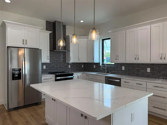 a kitchen with a refrigerator a sink and a stove