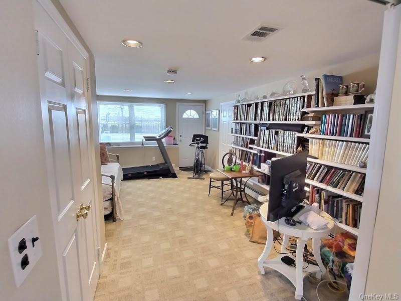 3421 Turf Road Oceanside, NY 11572 - Photo 48 of 50 a living room with furniture and a book shelf