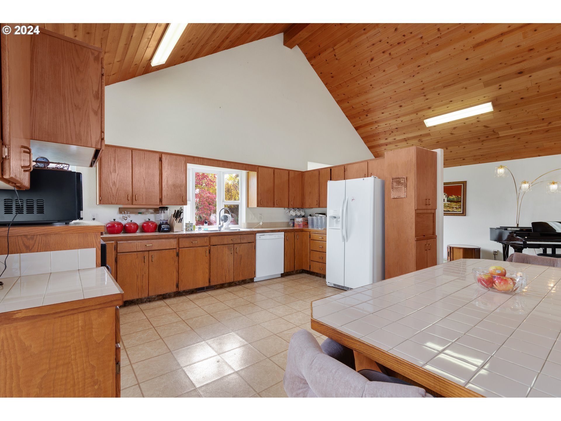 29264 South Barlow Road Canby, OR 97013 - Photo 8 of 46 a kitchen with stainless steel appliances kitchen island granite countertop a table chairs in it and wooden floors