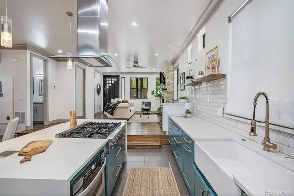 a kitchen with counter top space a sink stainless steel appliances and cabinets