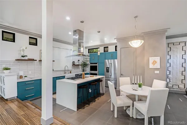 a kitchen that has a table and chairs in it