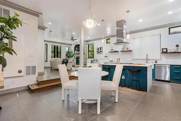 a large kitchen with a table and chairs