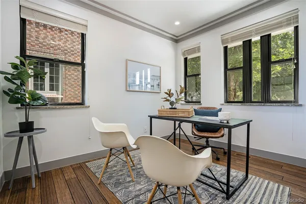 a view of a workspace with furniture window and wooden floor