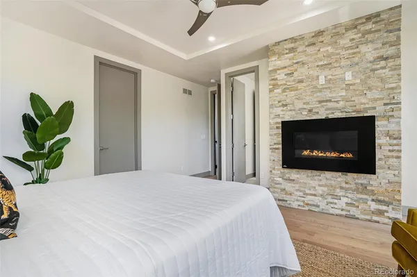 a bedroom with a bed and a fireplace