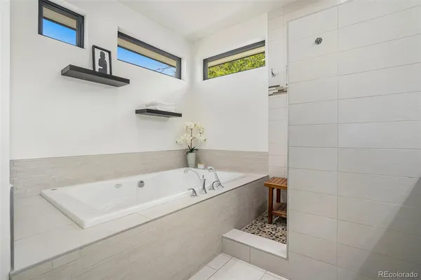 a bathroom with a bathtub and a shower