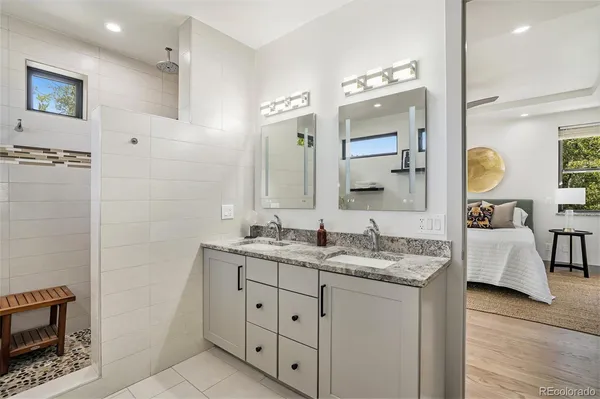 a bathroom with a double vanity sink a mirror and a
