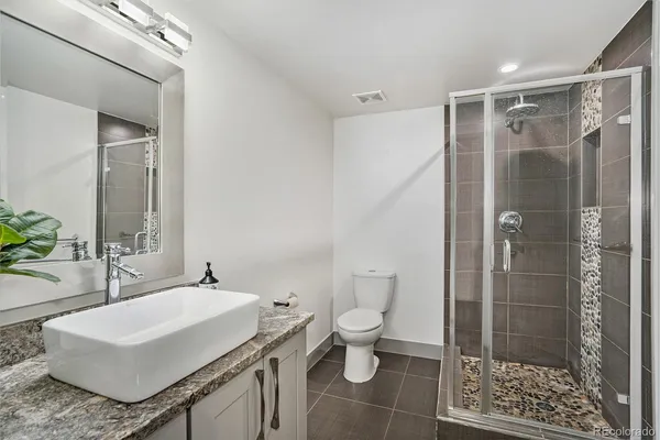 a bathroom with a sink toilet a mirror and shower
