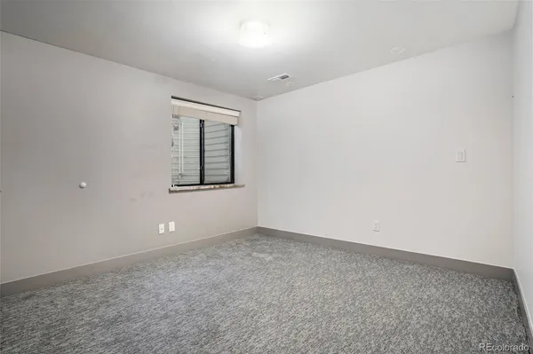 an empty room with windows and closet