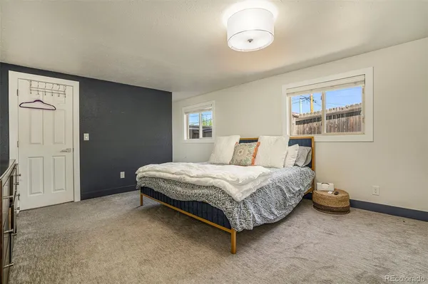a spacious bedroom with a bed and a window