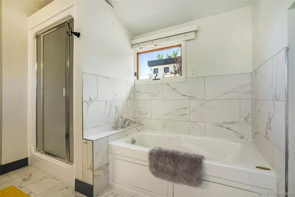 a bathroom with a bathtub and a shower