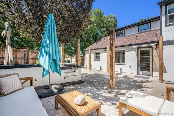 a view of a chairs and tables in the back yard of the house