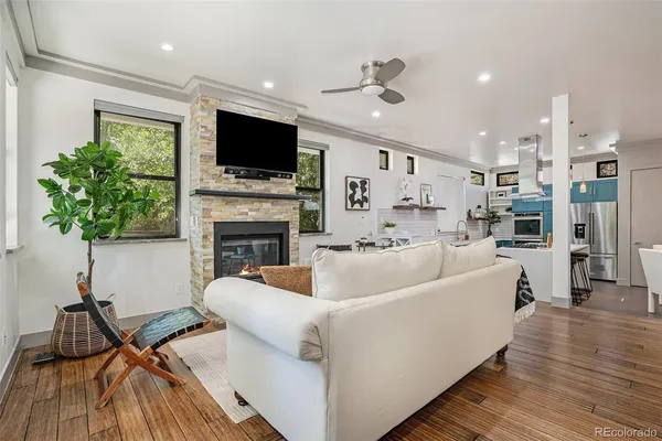 a living room with fireplace furniture and a flat screen tv