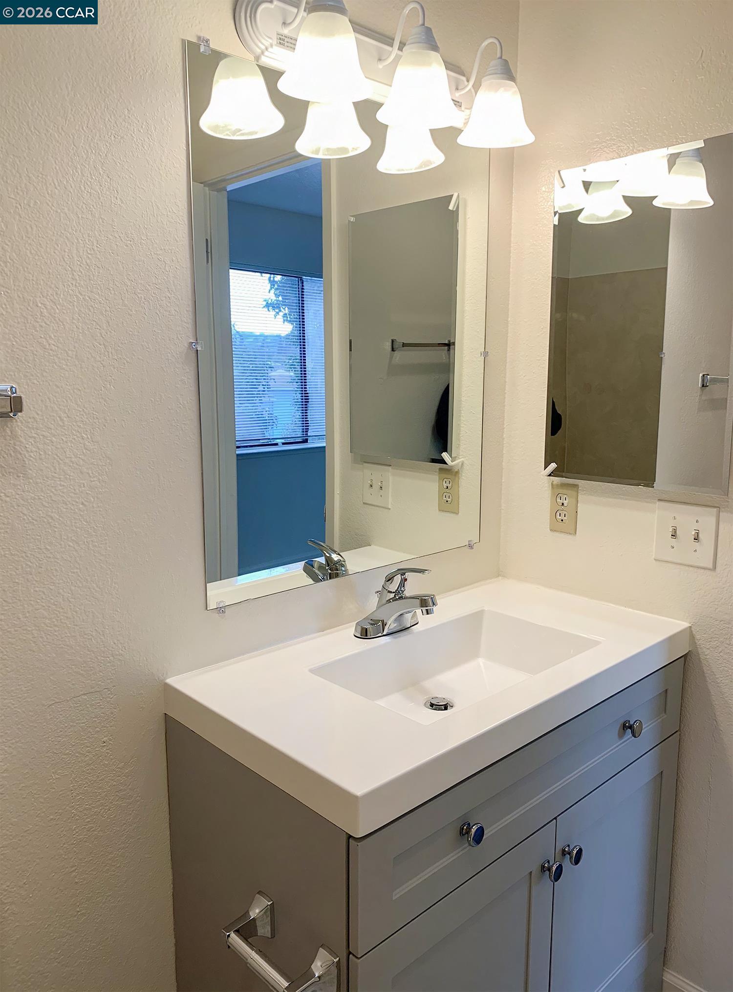 568 Dean Street Hayward, CA 94541 - Photo 12 of 17 a bathroom with a sink and a mirror