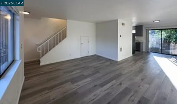 a view of a hallway with wooden floor and entryway