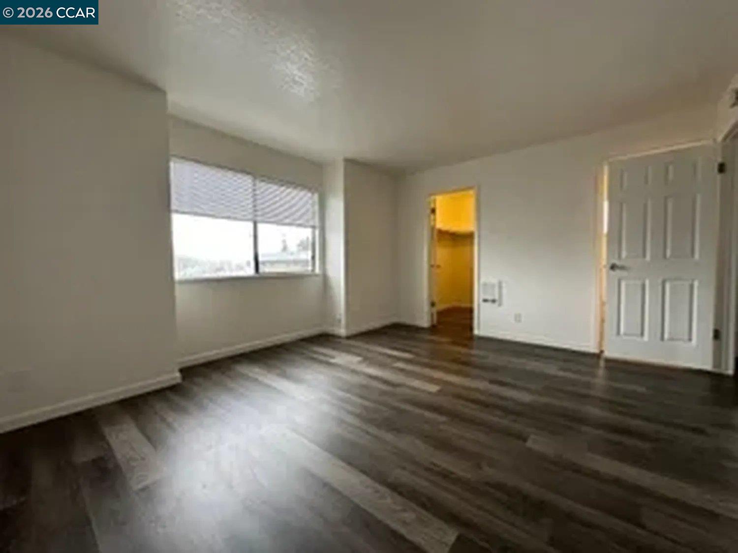 568 Dean Street Hayward, CA 94541 - Photo 3 of 17 an empty room with wooden floor and windows