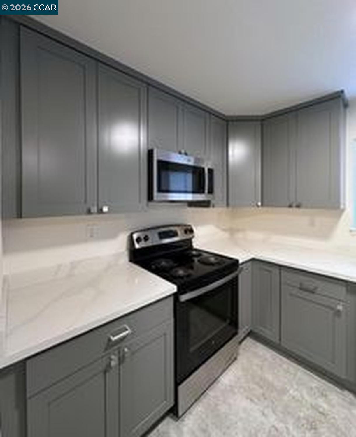 568 Dean Street Hayward, CA 94541 - Photo 4 of 17 a kitchen with granite countertop a stove and a sink