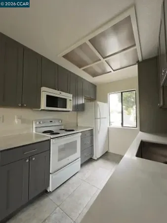 a kitchen with stainless steel appliances kitchen island granite countertop a sink and cabinets