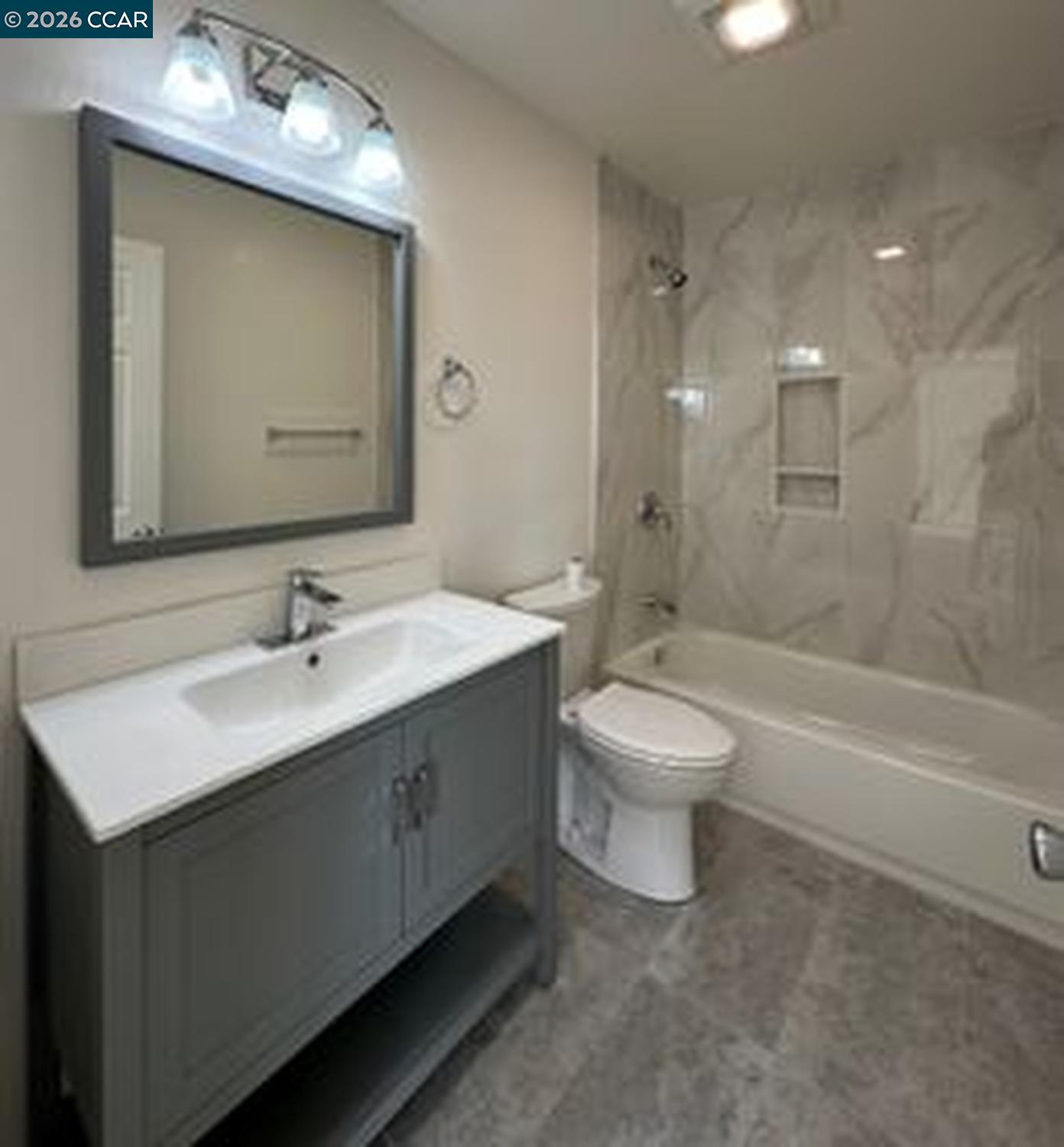 568 Dean Street Hayward, CA 94541 - Photo 7 of 17 a bathroom with a double vanity sink toilet mirror and bathtub