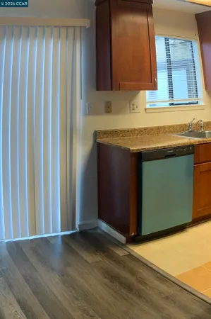 a kitchen with granite countertop wooden cabinets
